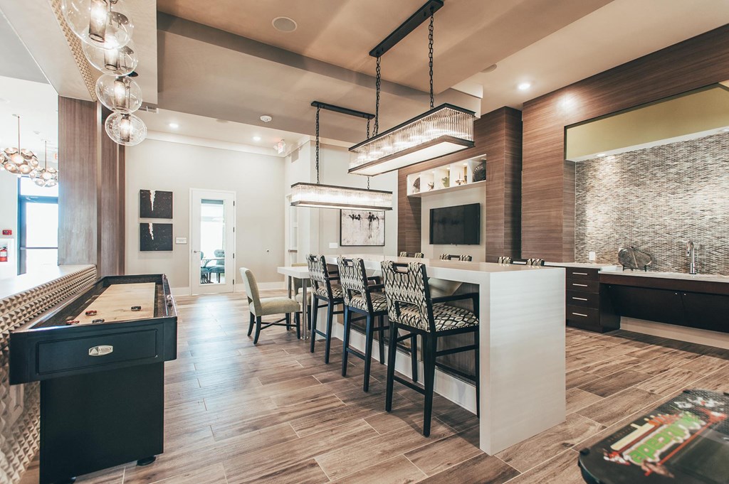 a kitchen with a long bar and a dining table