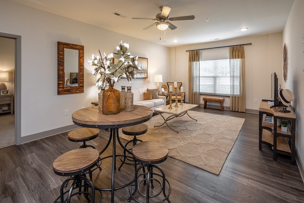 a dining room with tables and chairs and a ceiling fan