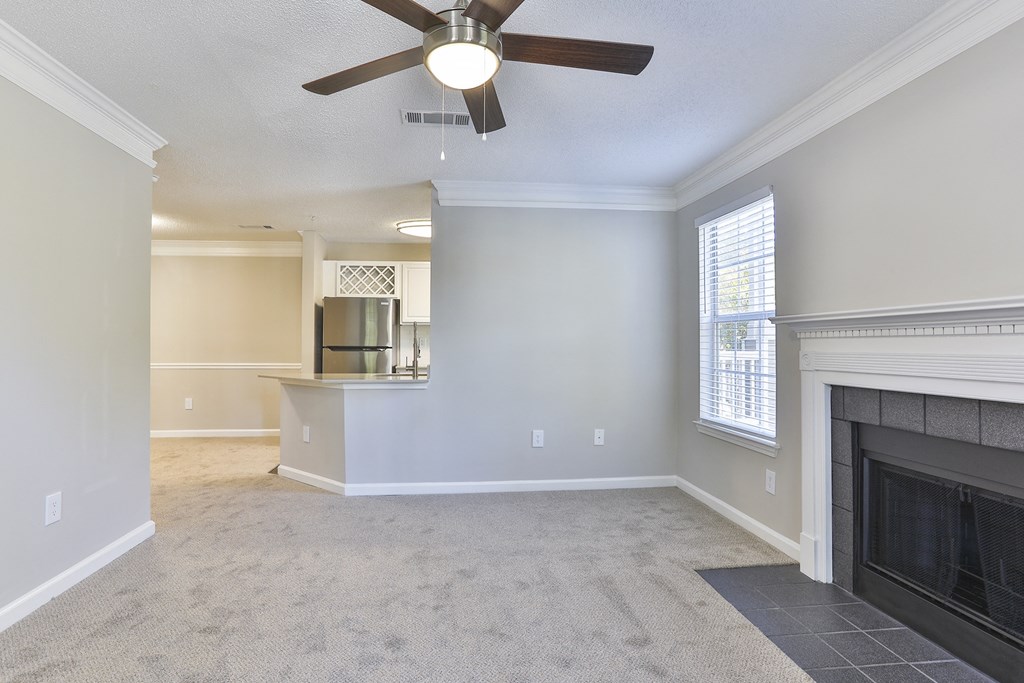 a living room with a fireplace and a ceiling fan at Crestmont at Thornblade, South Carolina