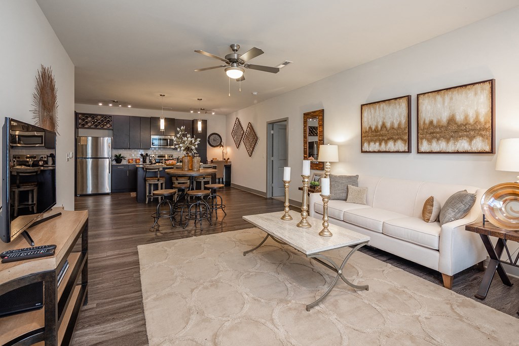 a living room with a white couch and a ceiling fan
