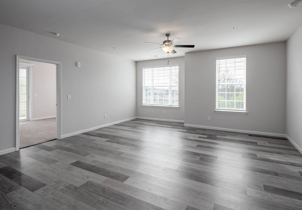 the living room with hardwood floors and a ceiling fan