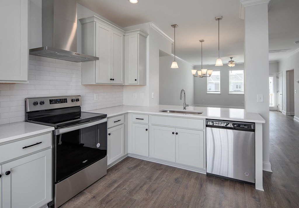 a kitchen with white cabinets and a black stove top oven