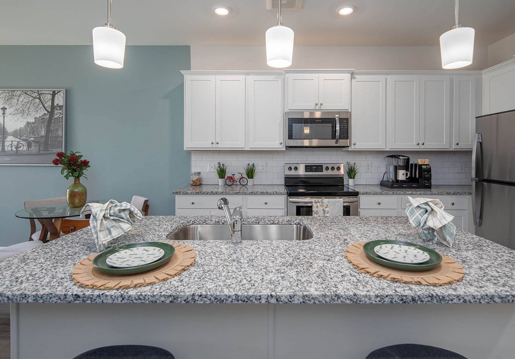 a kitchen with a large island with two plates on it