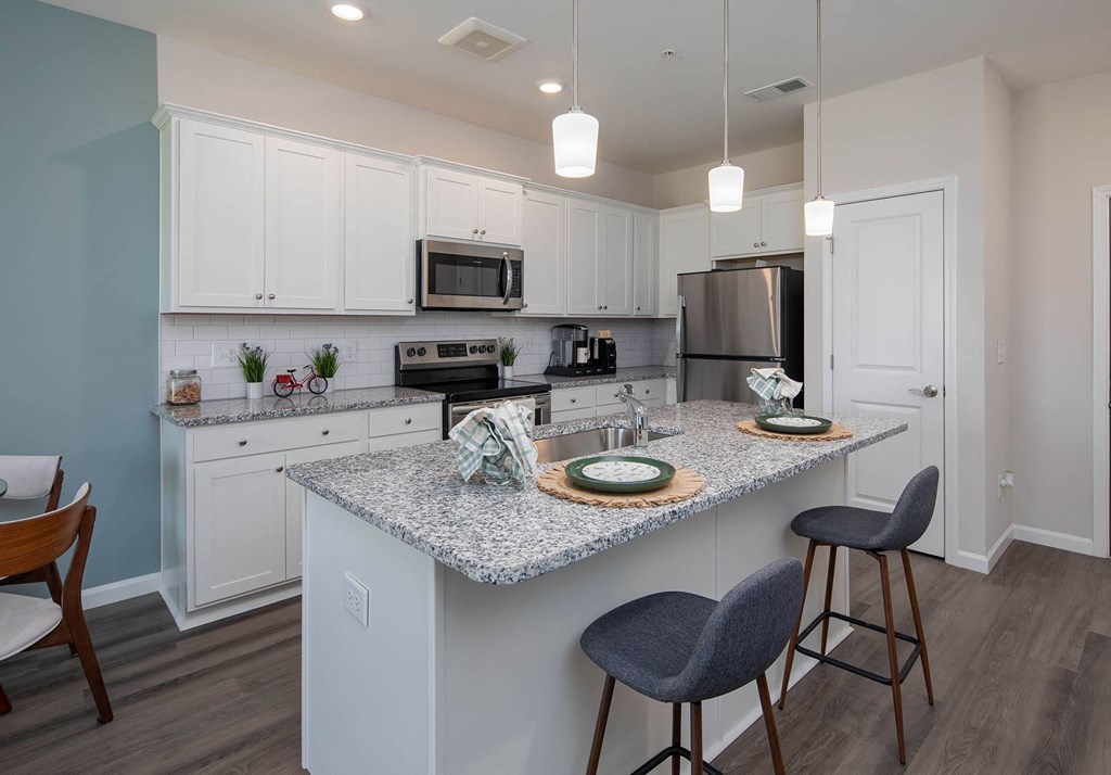 a kitchen with an island and two stools