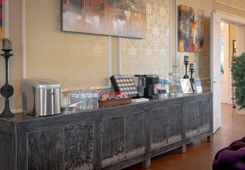 a coffee bar with a coffee machine and a toaster on top of a wooden counter