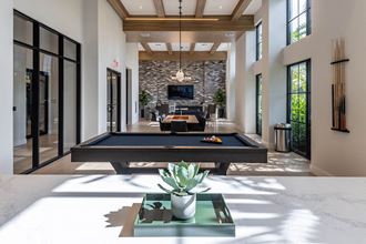 a large living room with a pool table and a television in the background - Photo Gallery 5