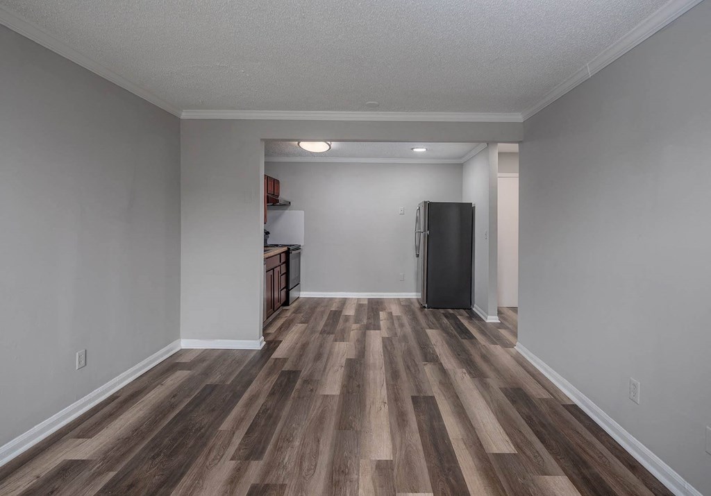 a bedroom with gray walls and a wooden floor