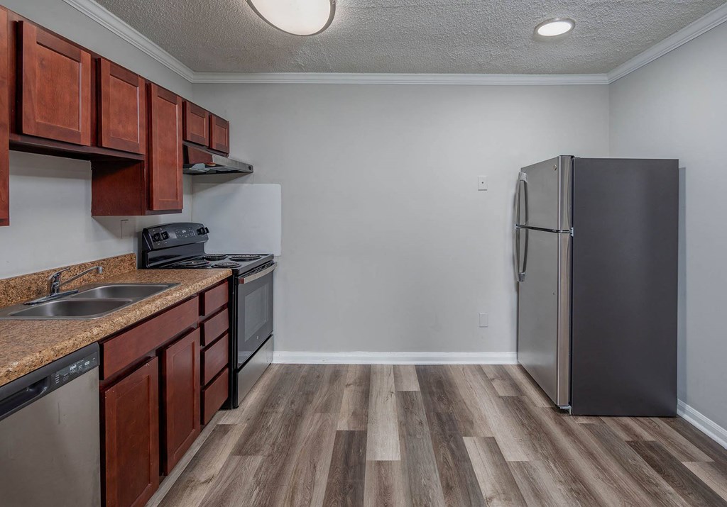 a kitchen with wooden cabinets and stainless steel appliances