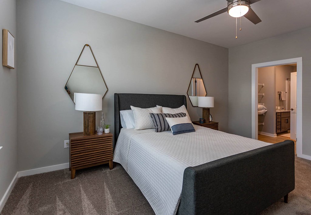 a bedroom with a bed and a ceiling fan