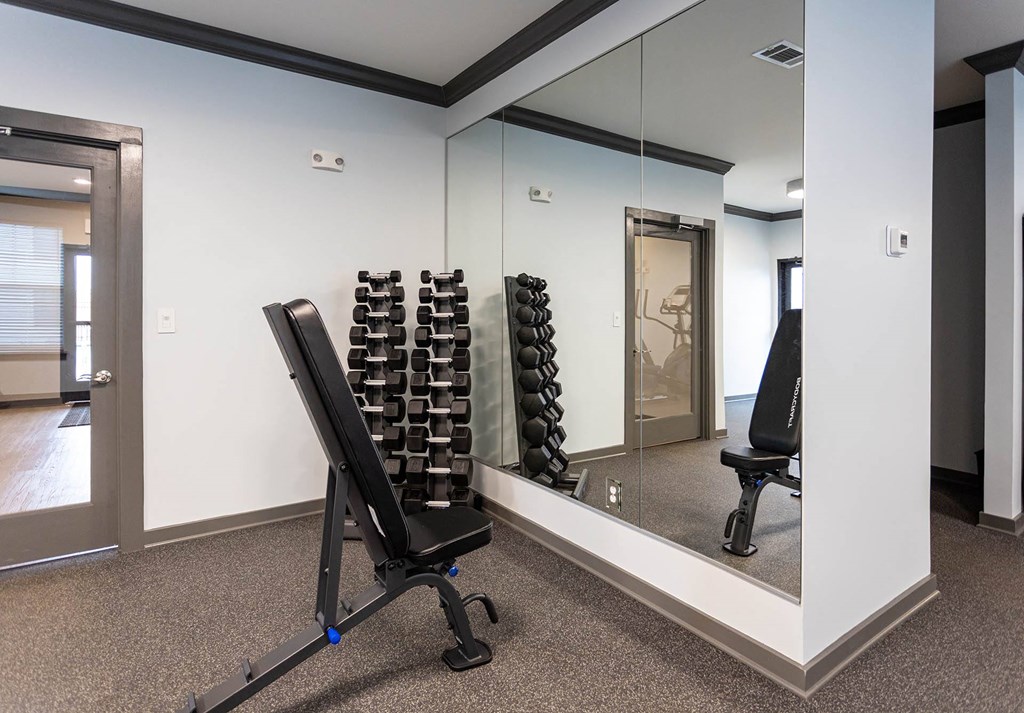 a home gym with a large mirror