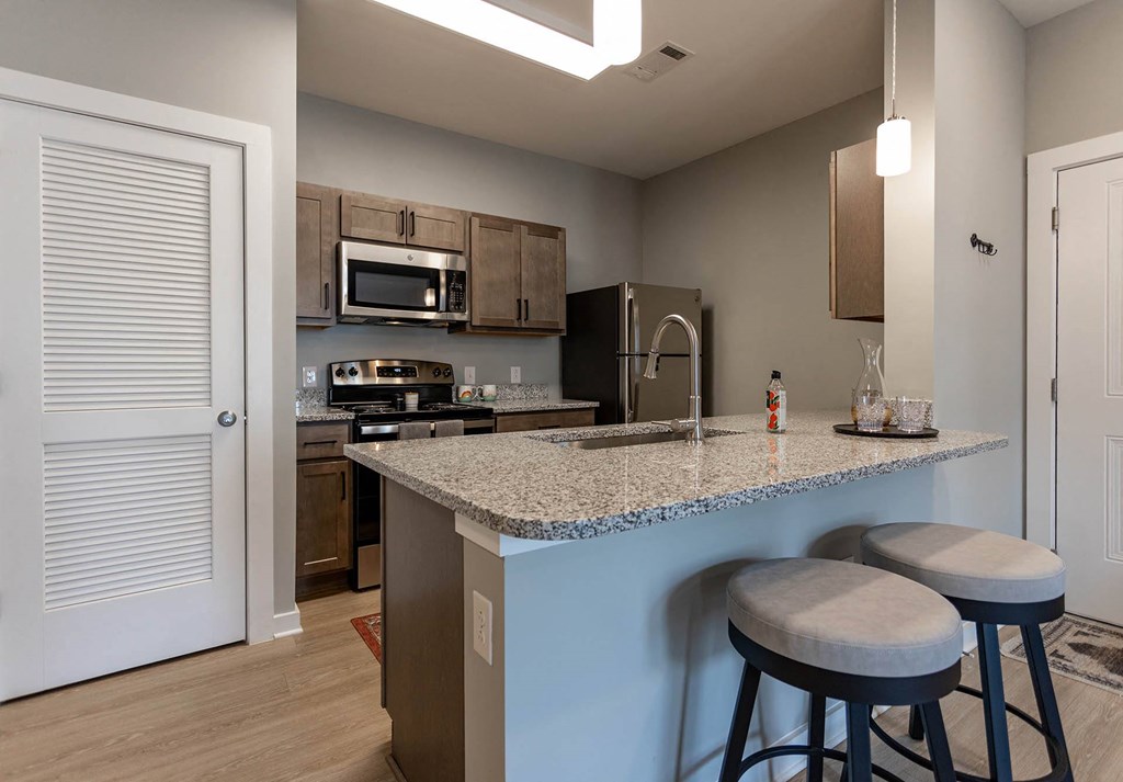 kitchen with granite countertops at the flats at big tex apartments in san antonio,