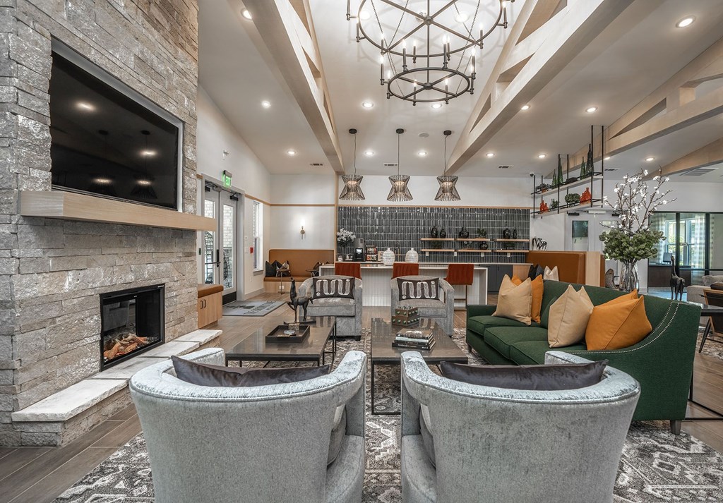 a living room with couches and chairs and a fireplace