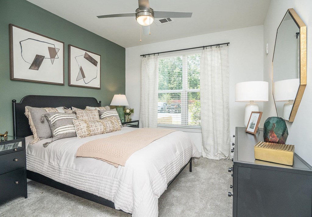 a bedroom with a bed and a ceiling fan