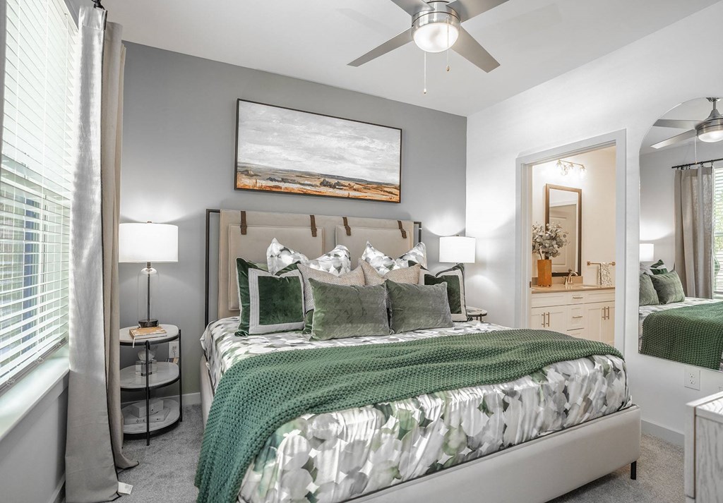 a bedroom with a bed and a ceiling fan