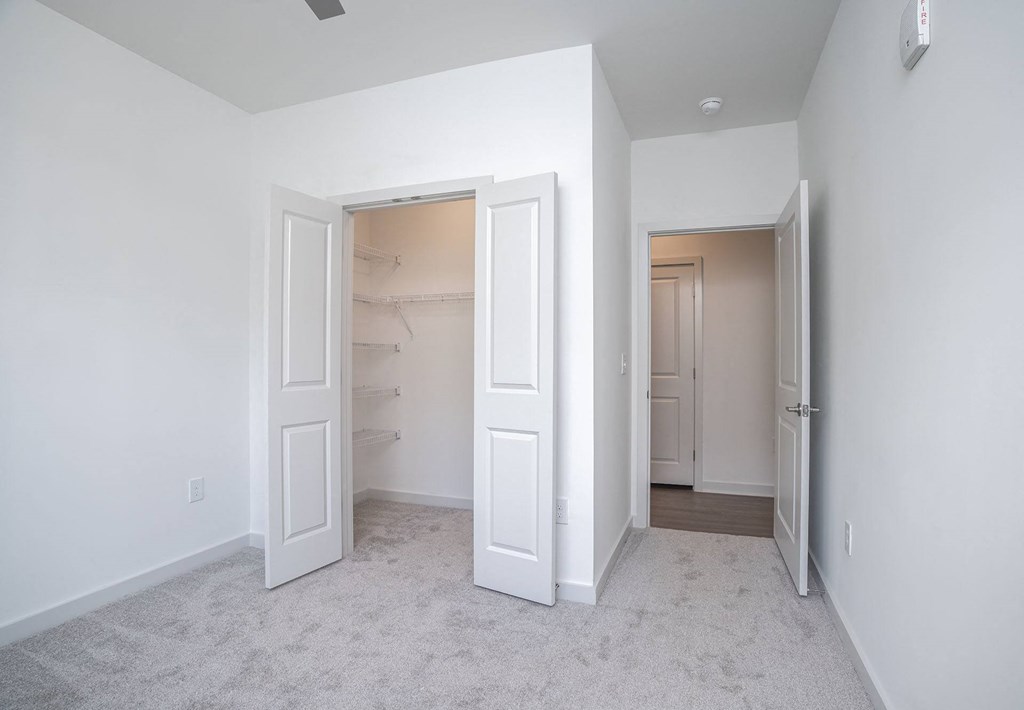 a bedroom with a closet and an open door