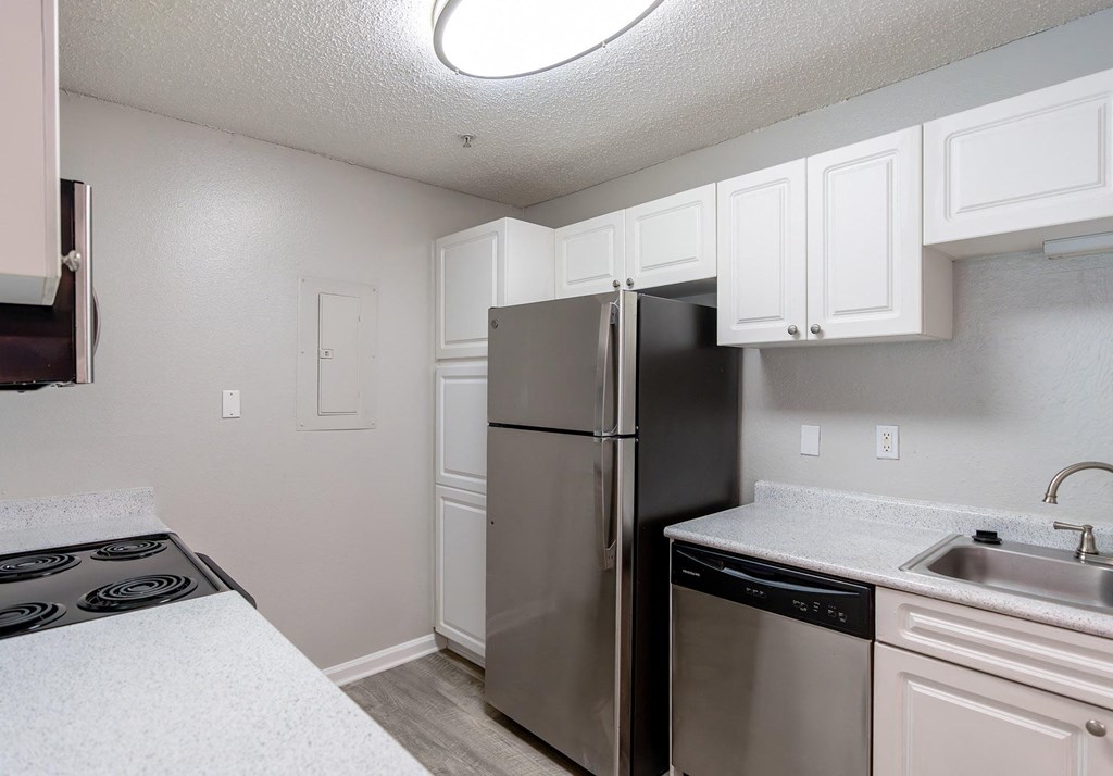 a kitchen with stainless steel appliances and white cabinets