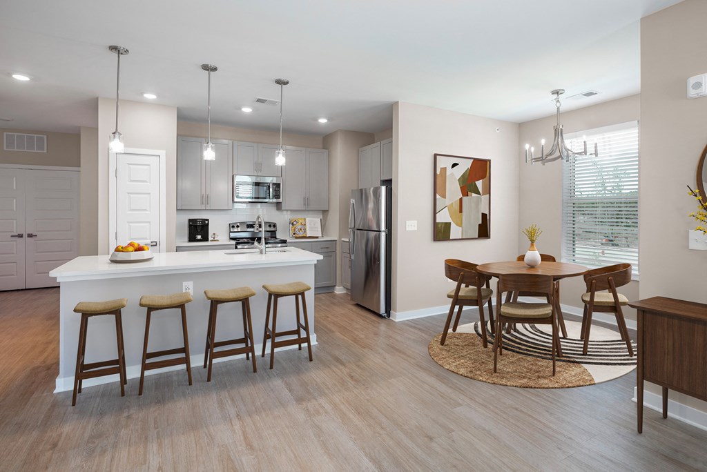 an open kitchen and dining room with a table and chairs