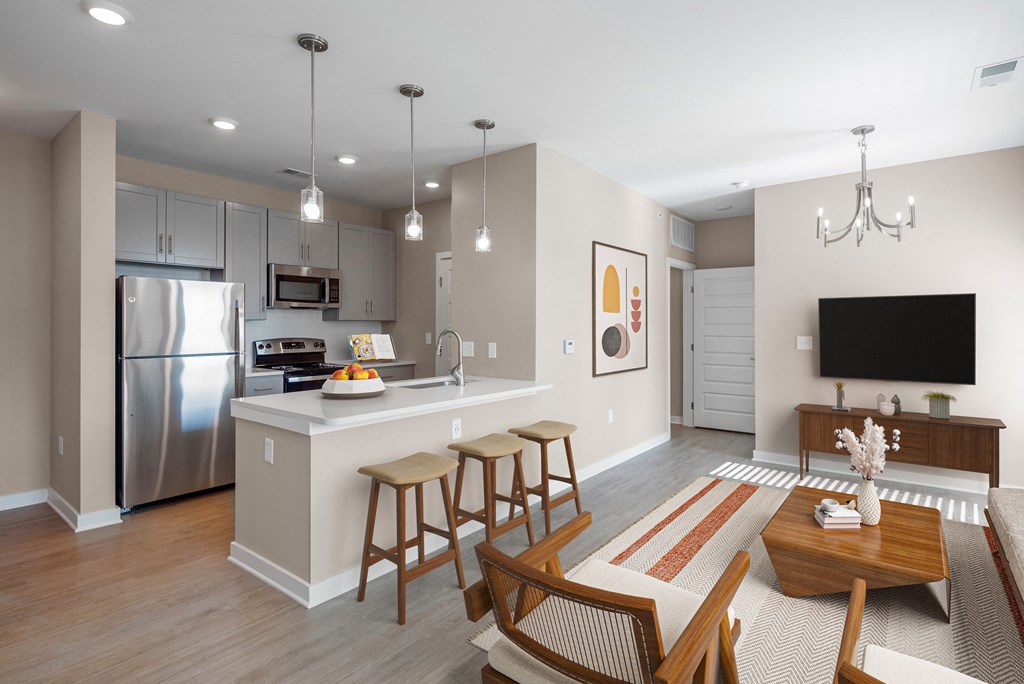 an open kitchen and living room with a dining room table and chairs