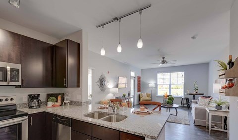 A modern kitchen with dark brown cabinets and a white countertop.