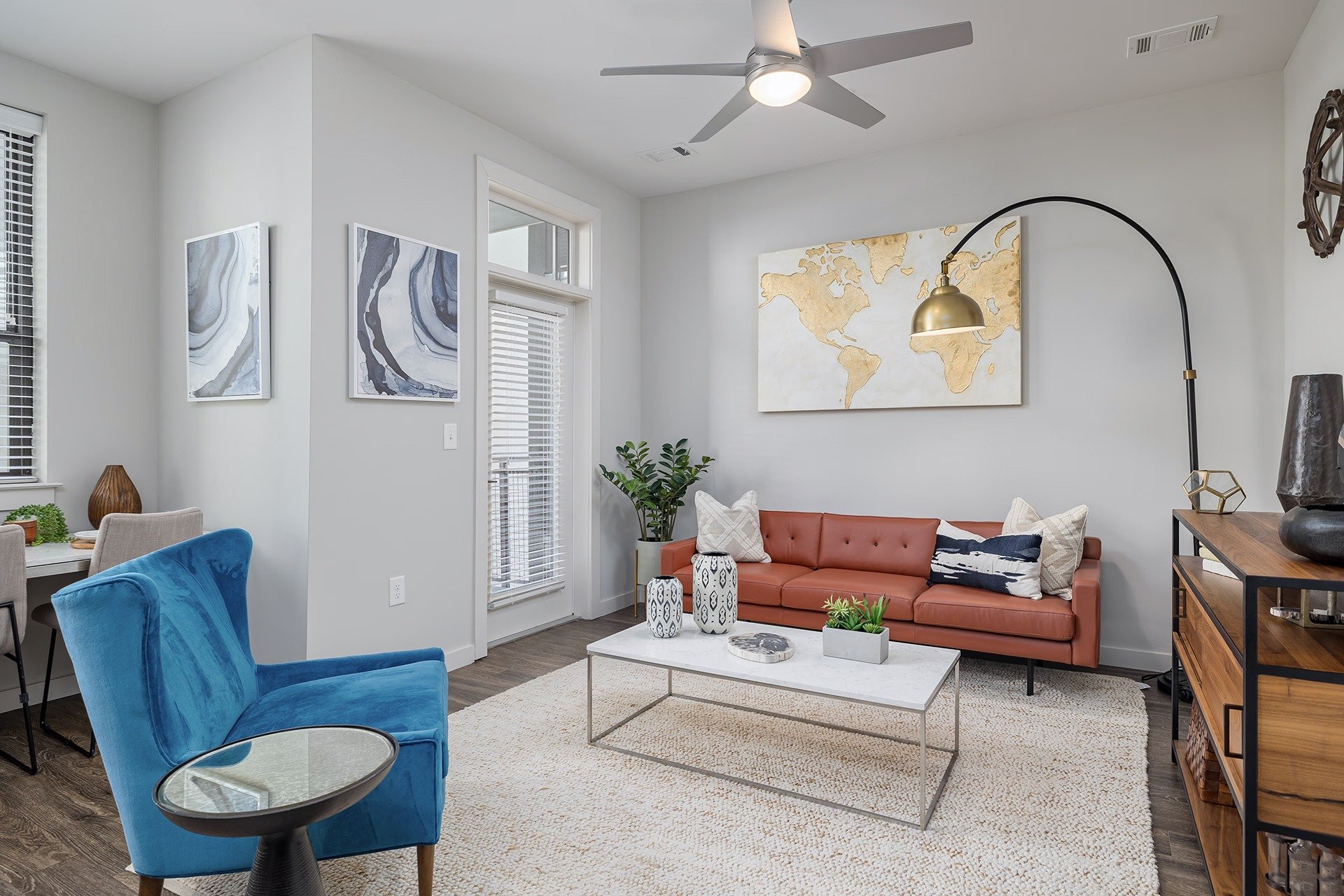A living room with a blue chair and a red couch.