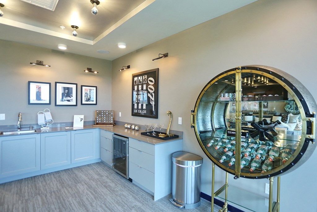 a large glass display case in the corner of a room with a sink and a trash can