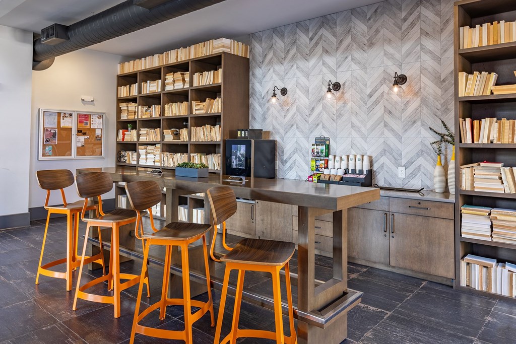 a bar with stools and chairs in a library