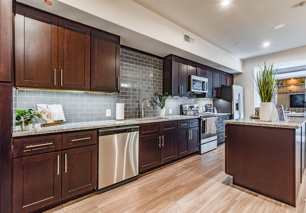a kitchen with wooden cabinets and stainless steel appliances