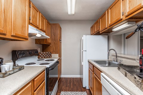 a kitchen with wooden cabinets and a white refrigerator