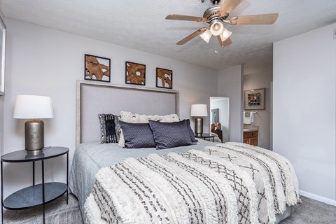 a bedroom with a large bed and a ceiling fan