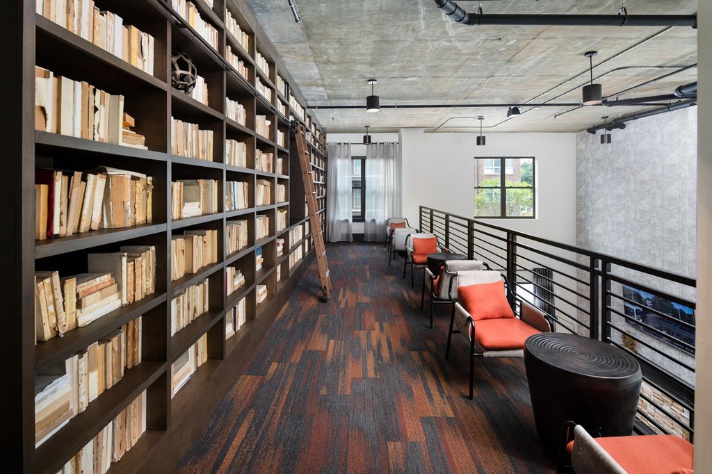 a library with a row of chairs and bookshelves