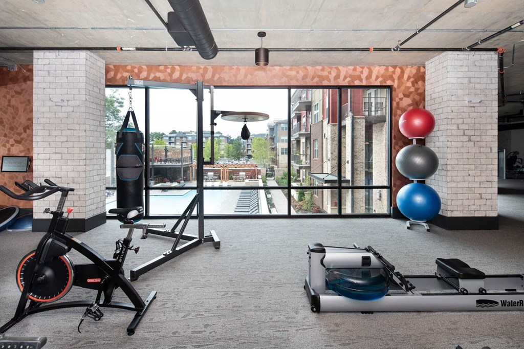 a gym with a view of the city from the window