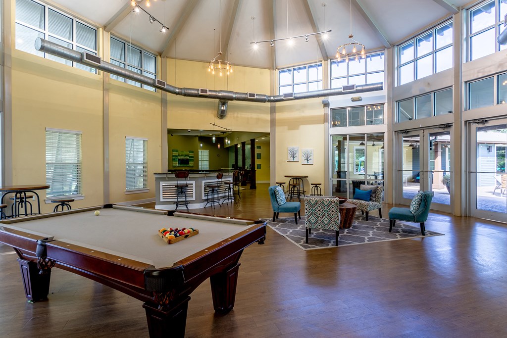 a large room with a pool table in the center