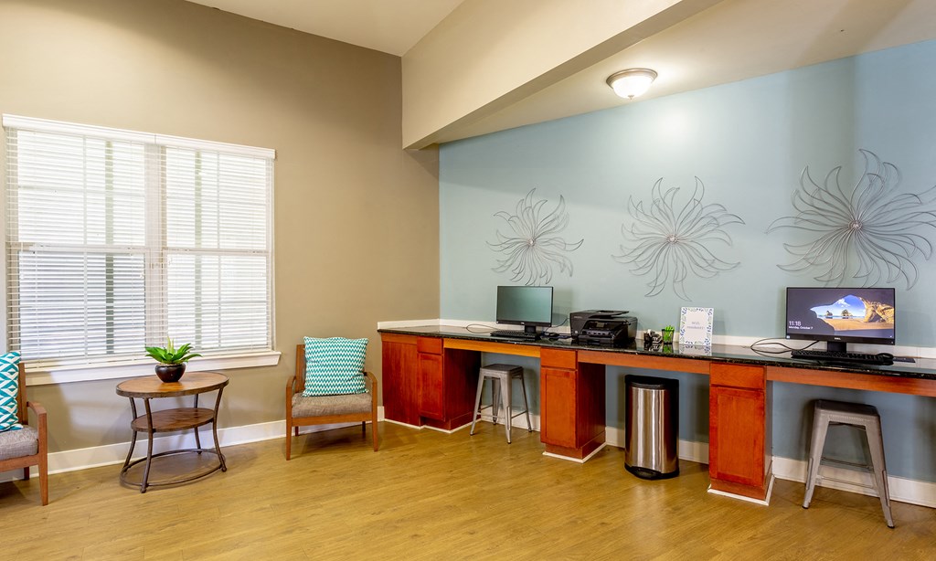 a living room with a desk and a computer on it