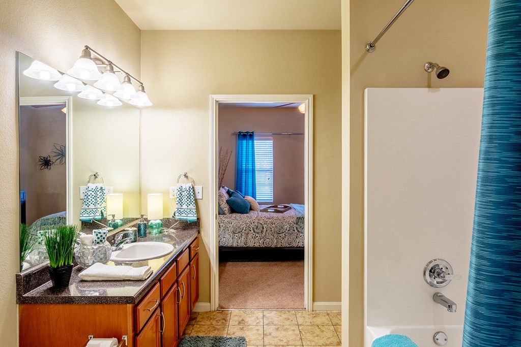 a bathroom with a shower and a sink and a mirror