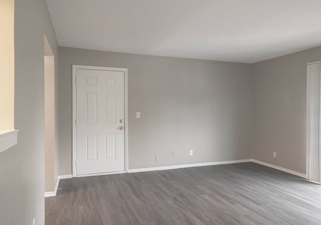 a bedroom with gray walls and a white door