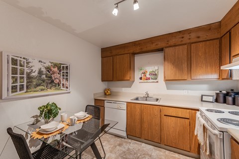 a kitchen with a table and chairs and a sink