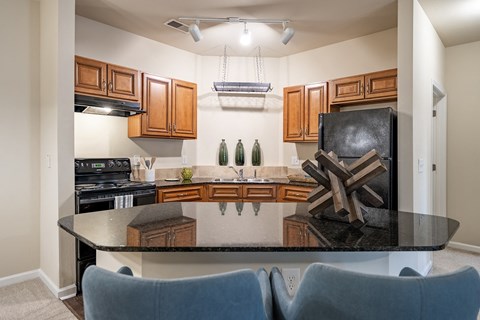 a kitchen with a black counter top and a black