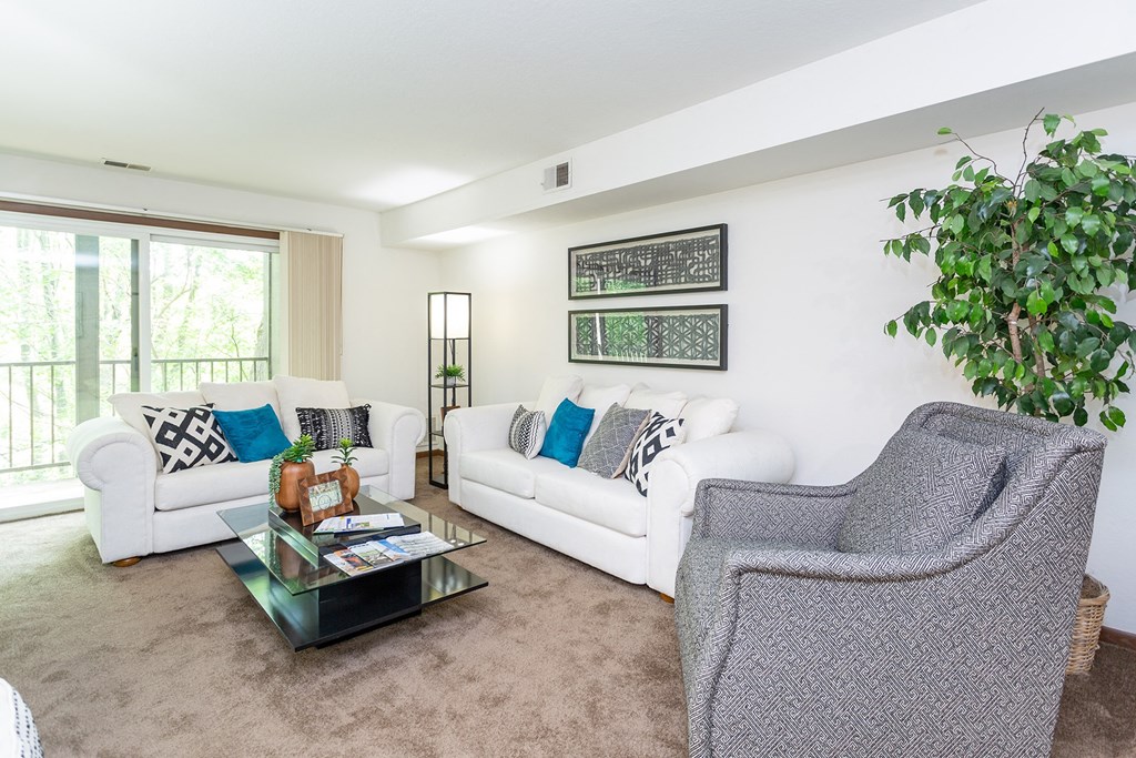 a living room with white couches and a glass coffee table at Winchell Way Apartment, Kalamazoo, MI, 49008