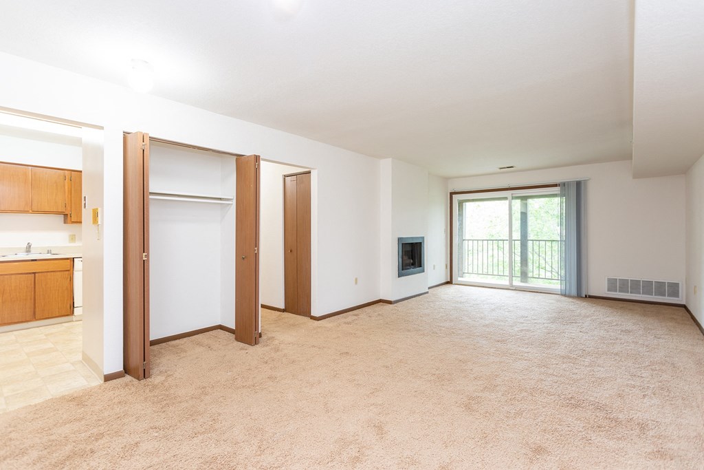 an empty living room with a kitchen in the background at Winchell Way Apartment , Kalamazoo, 49008