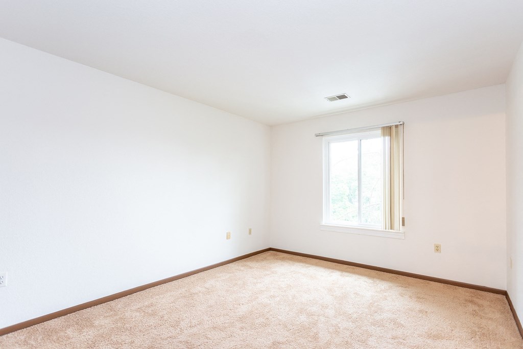 a bedroom with white walls and a window at Winchell Way Apartment , Kalamazoo, MI