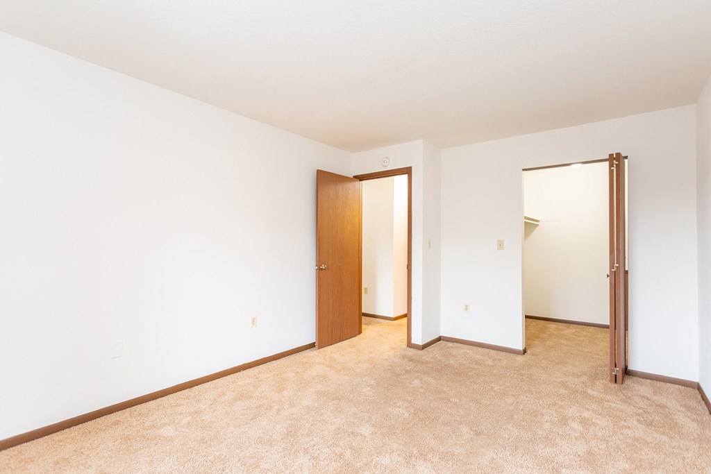 a bedroom with white walls and carpet at Winchell Way Apartment , Kalamazoo, Michigan