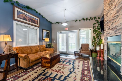 the living room of a house with a couch and a rug