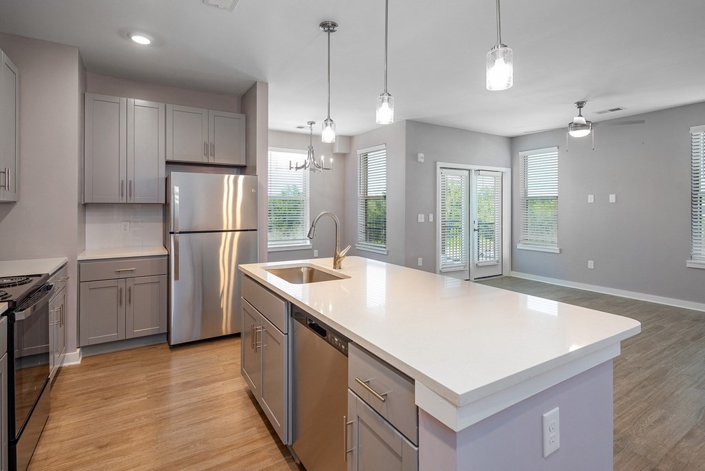 Apartments for Rent in Mt. Juliet TN - The Enclave - Kitchen with Hardwood-Style Flooring, Stainless Steel Appliances, Shaker-Style Cabinets, Spacious Kitchen Island with Pendant Lights, and Granite Countertops