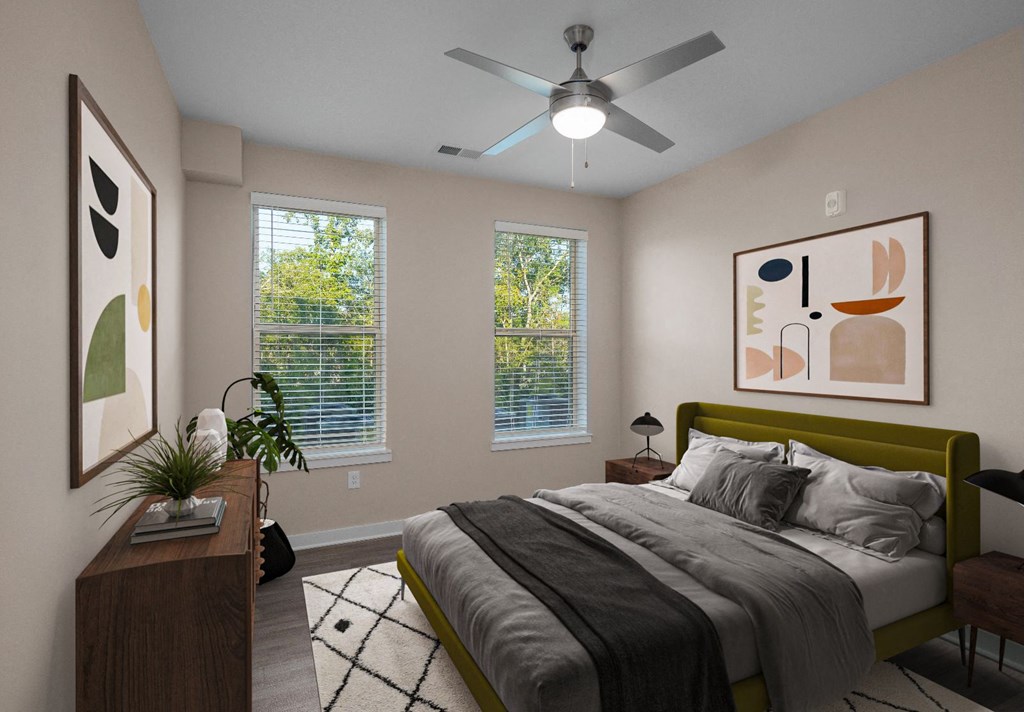 2-Bedroom Apartments in Mt. Juliet, TN - The Enclave at Providence - Bedroom with Hardwood-Style Flooring, Area Rug, Bed, Nightstands with Lamps, Dresser, Ceiling Fan, and Two Windows.