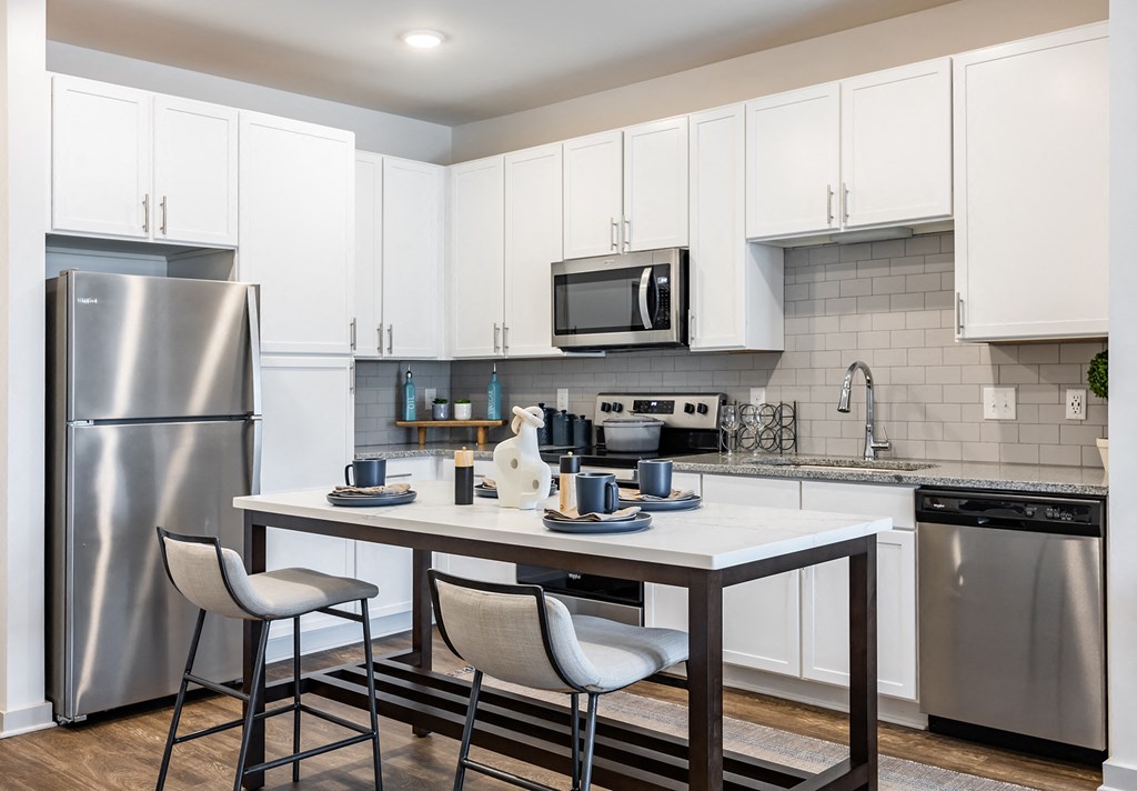 Luxury Apartments In Antioch, TN - Novo Hickory Highlands - Chef-Inspired Kitchen With Whirlpool Stainless Steel Appliance, Package 42” Shaker Cabinetry, Granite Counters, And Movable Kitchen Islands