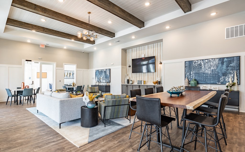 a living room and dining room with a table and chairs