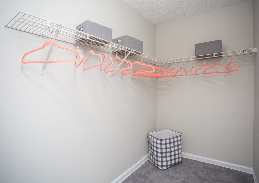 an empty room with a wire rack on the wall and a box on the floor