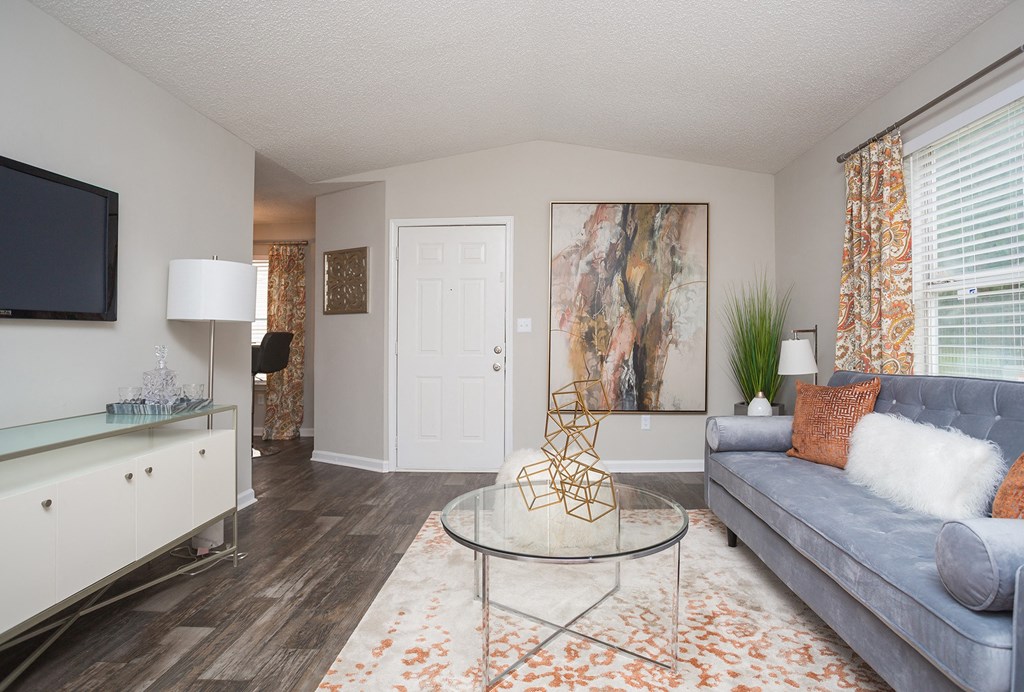 a living room with a couch and a glass table
