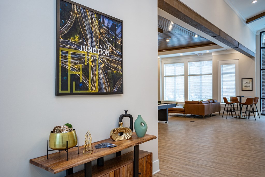 a living room with a table and a painting on the wall