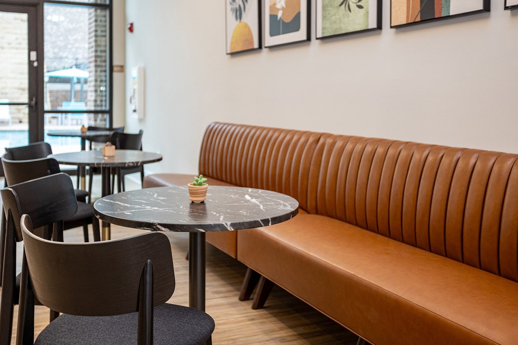 a seating area with a table and chairs and a wall with a bunch of wallpaper